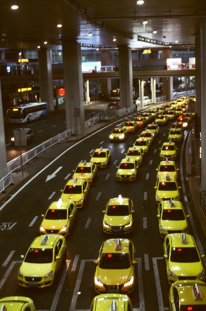 The Art of Drawing Readers In: Your attractive post title goes here Aerial view of yellow taxis in an urban setting, showcasing a busy city traffic jam at night.